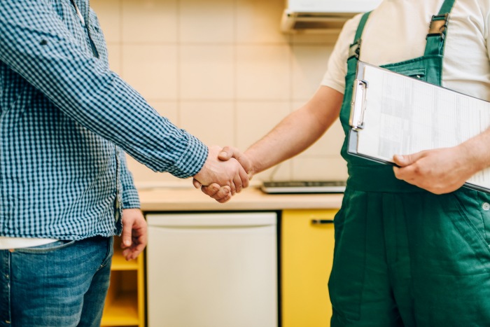 handyman and customer shake hands